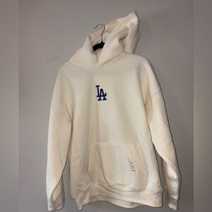 Genuine Merchandise Cream Hoodie with Blue Emblem